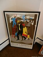 Full view of the framed poster leaning against a wall