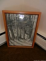 Full view of framed pencil drawing showing entire art piece leaning against wall.