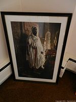 Framed poster of Eduard Charlemont's The Moorish Chief leaning against wall, showing full artwork and frame detail.