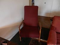 Front view of maroon upholstered chair showing overall condition and design