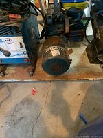 Front and side views of the blue Winco portable generator showing motor and connection ports.