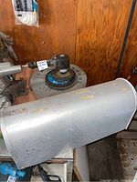 Side view of Forray air grinder with visible grinding wheels and vintage U.S. mailbox on a metal surface.