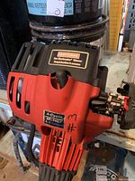 Close-up photo of the red and black Craftsman 4-cycle engine housing with '4-Cycle Motor 4-temps' label visible.