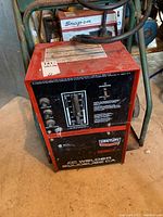 Front view of welder mounted on cart with visible control panel and cables