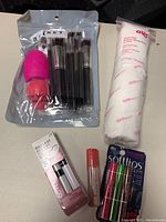 Full set of makeup accessories displayed on black background, showing all items in the lot