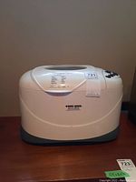 Front view of the white Black & Decker bread maker showing overall design and logo.