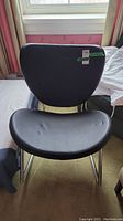 Black vinyl Casalife rocker chair facing forward, showing contoured padded seat and backrest.