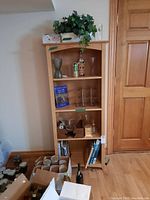 Front view of the wooden shelf unit with items displayed on the shelves to show shelf structure and size.