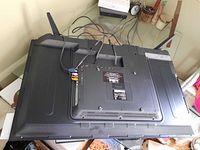 Back view of Element TV showing the full rear panel with various input ports and cables attached.