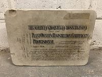 Front side of the limestone print block showing Toronto Compressor Operators Certificate text for 1928 with dates and registration details.