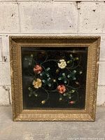 Full front view of the antique shadowbox showing the floral design and gold frame.