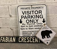 Three metal signs shown together - Visitor Parking Only, Bear Crossing, Fabian Crescent