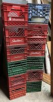 Stacked vintage plastic milk crates in red, green, and blue colors branded Sealtest and Silverwood