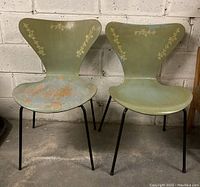 Front view of both chairs showing overall appearance, painted finish, stencil decoration and legs