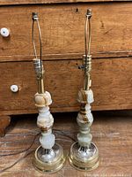 Pair of vintage onyx stone table lamps with metal bases showing overall height and structure.