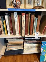 Books on shelves including topics such as U.S. history, Native American studies, and travel guides.