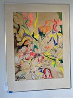 Frontal view of framed floral painting with multiple bright colors and signature 'Arnold' in corner.