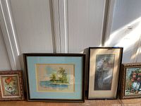 View of four framed artworks arranged side by side showing variety of floral and landscape themes