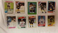 Front view of 10 vintage NHL hockey cards featuring players in various poses on different teams.