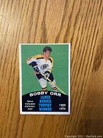 Front of Bobby Orr 1970-71 O-Pee-Chee hockey card showing player image and James Norris Trophy text.