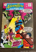 Front cover of Adventure Comics #370 depicting Superboy and the Legion of Super-Heroes tied up and surrounded by characters and a large monster, with bold text 'The Devil's Jury!'.