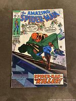 Front cover of The Amazing Spider-Man #90 comic, color illustration showing Spider-Man holding a man while crowds accuse him of murder.