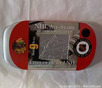 Metal tin case with NHL All-Stars 2001 Stamp and Medallion Set branding, featuring Chicago Blackhawks logo and Bobby Hull's name.