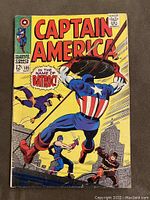 Front cover of Captain America #105 comic book showing Captain America fighting villains on a city rooftop with bright yellow background.