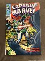 Front cover of Captain Marvel #7 comic book, showing the main character firing a laser with bold title and issue details.