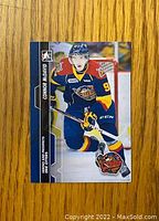 Front side of Connor McDavid rookie card showing player in Erie Otters uniform skating on ice, card #5.