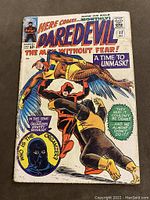Front cover of Daredevil #11 comic showing Daredevil fighting two adversaries with text 'A Time to Unmask!' and cover details including Marvel stamp box, cover price 12 cents, dated December.