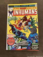 Front cover of The Inhumans #1 comic book showing colorful action scene of Inhumans characters including Black Bolt and Blastaar