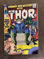 Front cover of Journey Into Mystery comic issue #122 showing Odin on throne, Thor, and chained man with ball and chain.