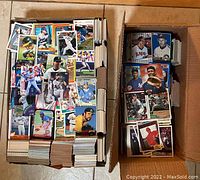 Two boxes filled with baseball cards showing various players in colorful baseball uniforms.