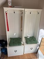 Front view of both white wood hall tree bench units side by side