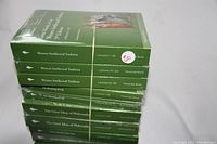 Photo showing a stack of 10 sealed "Great Courses" books in original shrink wrap, titles visible on the spine relating to Western Intellectual Tradition, The Meaning of Life, and The Great Ideas of Philosophy lecture series.
