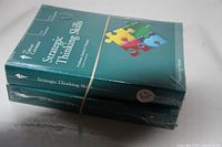Two original sealed books stacked, titled Strategic Thinking Skills and another related to critical thinking skills from The Great Courses academic lecture series.