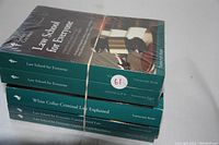 Five sealed books stacked and secured with a rubber band, spine titles visible. The books pertain to law topics and are part of The Great Courses academic lecture series.