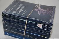 Stack of six Great Courses books in original sealed wrapper except one, bound with rubber band. Titles include Understanding Complexity, Crashes and Crises, America and the New Global Economy (two volumes).