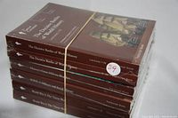 Stack of six sealed The Great Courses hardcover books on history and military topics, wrapped in plastic and rubber band.