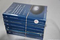 Stack of six sealed Great Courses books on physics and mathematics topics in original wrapping tied with a rubber band.