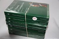 Stack of seven green, hardcover Great Courses books in original sealed wrappers with clear titles and lecture numbers shown, bound by a rubber band.