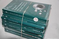 Stack of seven Great Courses transcript books in sealed plastic wrap, titles visible on spines.