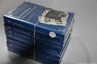 Stack of seven sealed Great Courses books on biology and science topics, still wrapped in original plastic and secured with a rubber band