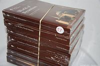 Stack of eight sealed hardcover Great Courses books on ancient history topics bound with rubber band