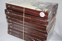 Stack of eight sealed Great Courses history transcript books showing titles including Victorian Britain, inventions, Hitler's Empire, exploration voyages, Churchill, and Eastern Europe.