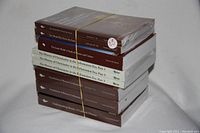 Photo shows nine academic lecture series books stacked in two piles, mostly wrapped in original shrink-wrap, titles focused on history, civilization and culture topics. Books bundled with a rubber band.