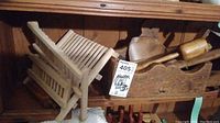 Wooden drying rack with multiple slats, wooden box, wooden paddles and rolling pin in wooden box.