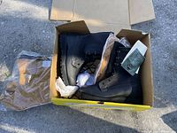 Photo showing a pair of black Belleville boots inside a shoebox, with tan boot inserts outside the box in plastic wrapping.