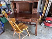Full view of the wooden mission style desk paired with a wooden dining chair, showing overall structure and condition.